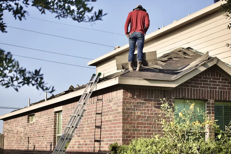 Professional roofer working on a residential roof in Marina West